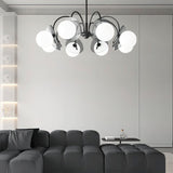 "Copper Dyana chandelier with frosted glass globes hanging above a modern living room with a grey sectional sofa."
