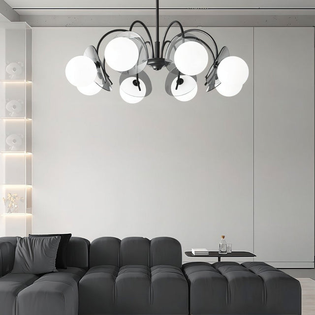 "Copper Dyana chandelier with frosted glass globes hanging above a modern living room with a grey sectional sofa."