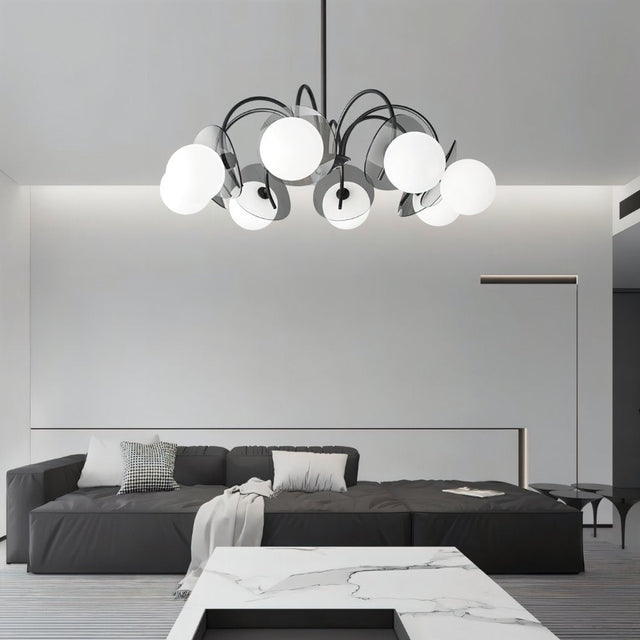 "Copper Dyana chandelier with frosted glass globes hanging above a living room with a grey sofa and marble table."