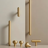 "Set of modern minimalist brushed brass knobs and pull bars for kitchen, bathroom, or bedroom cabinets."