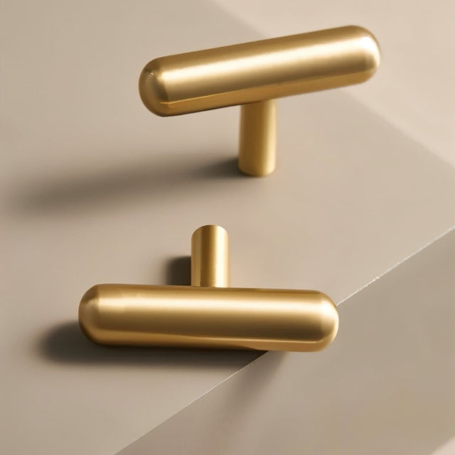 "Modern minimalist brushed brass T-bar pulls for contemporary cabinets and drawers."