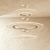 Three-tier stacked circular pendant light with geometric mesh pattern, warm brass finish, suspended in modern living room set