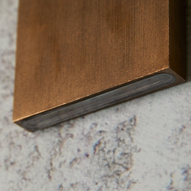 "bottom view of wall lamp, brass edge detail, modern light fixture close-up"