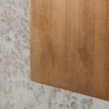 "close-up of brass lamp, textured surface, modern wall light detail"