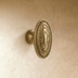 Ornate white ceramic cabinet knob with decorative carved detailing and beaded trim, shown from front angle with measurements.