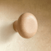 Mushroom-shaped decorative object with textured cap and cylindrical stem, shown against white background.