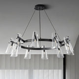 "A modern black brass chandelier with cone-shaped acrylic shades on a gray ceiling, angled view."