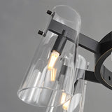 "Close-up of a modern black brass chandelier with cone-shaped acrylic shades and exposed bulbs."