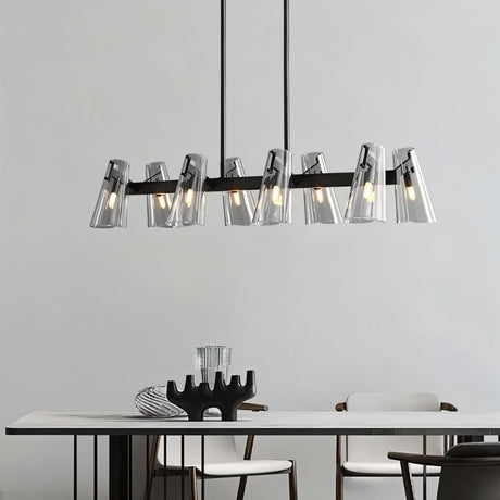 "A modern black brass linear chandelier with cone-shaped acrylic shades over a dining table."
