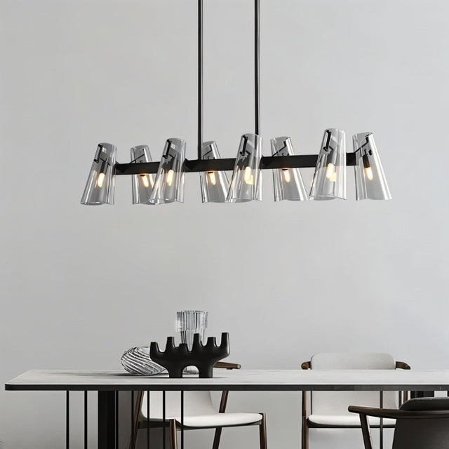 "A modern black brass linear chandelier with cone-shaped acrylic shades over a dining table."