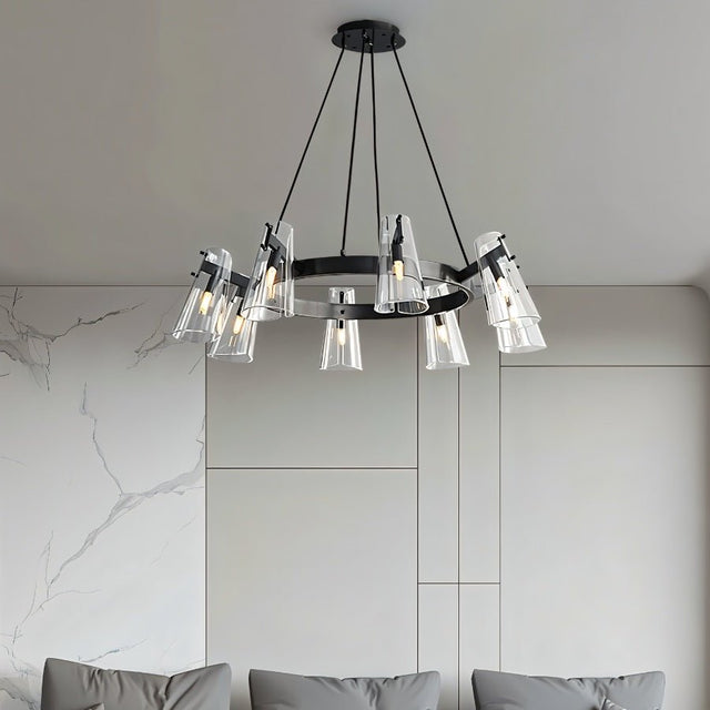 "A modern black brass chandelier with cone-shaped acrylic shades over a couch in a living room."