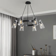"A modern black brass chandelier with cone-shaped acrylic shades hanging in a living room."