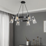 "A modern black brass chandelier with cone-shaped acrylic shades hanging in a living room."