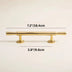 Gold-finished brass bar pull with cylindrical handles and round mounting bases on cream background.