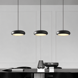 Set of three Emiva Pendant Lights above a dining table, offering balanced LED lighting for contemporary dining room interiors.