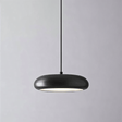 Close-up of Emiva Pendant Light against a gray background, showcasing its smooth matte black finish and integrated LED glow.