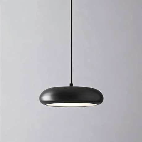 Close-up of Emiva Pendant Light against a gray background, showcasing its smooth matte black finish and integrated LED glow.