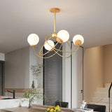 "Sculptural ceiling light with frosted glass globes and metal arms, illuminating a contemporary bedroom interior."