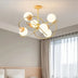 "Gold-finished ceiling light fixture with wood accents, adding elegance to a modern kitchen and dining space."