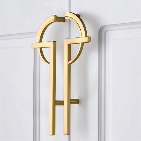 "brass pull bar mounted on stylish door with geometric accents"