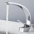 # White chrome single-handle bathroom faucet with curved spout shown running water on marble countertop.