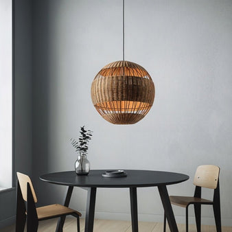 "Handcrafted rattan pendant light with spherical design and open weave, providing a warm, ambient glow. Perfect for dining room decor, featuring minimalist aesthetics and made of durable rattan material."