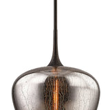 "close-up of textured glass pendant light with warm glowing bulb"