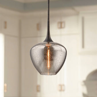 "single pendant light hanging with textured glass and warm light"