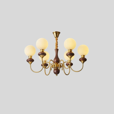 "Angled view of a gold and dark wood Eurot chandelier with six frosted glass globes, isolated on a light gray background."