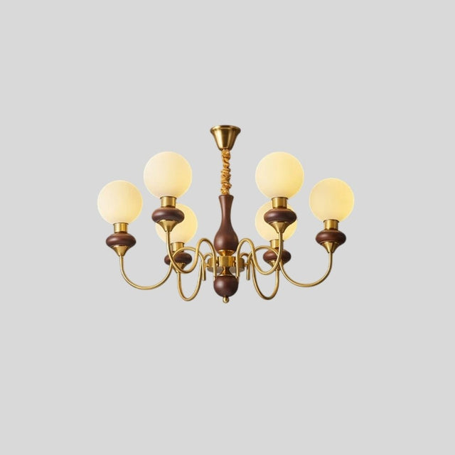 "Angled view of a gold and dark wood Eurot chandelier with six frosted glass globes, isolated on a light gray background."