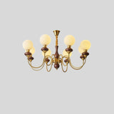 "Gold and dark wood Eurot chandelier with six frosted glass globes, isolated on a light gray background."