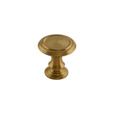 "Round, solid brass cabinet knob with intricate classical details and a golden finish."