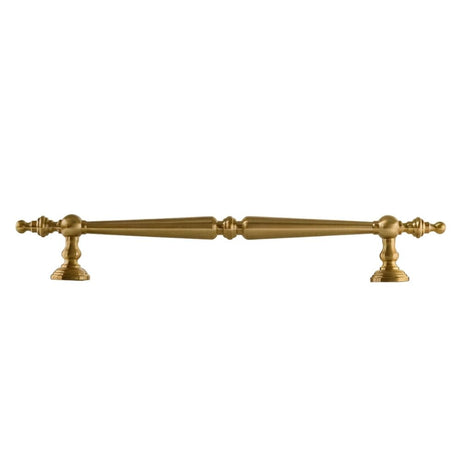 "Ornate brass pull bar handle with a tapered silhouette and intricate classical details."