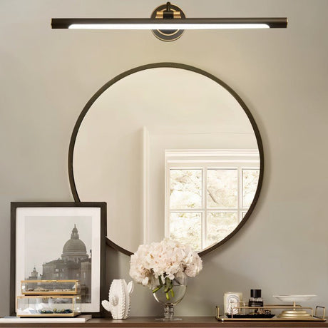 "A sleek black wall lamp with a horizontal bar design, mounted above a round mirror in a contemporary bathroom setting."
