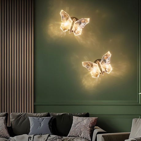 Two glowing neon butterfly wall lamps mounted on a green wall above a modern sofa with pillows.