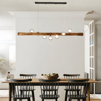 "Sleek Fayla pendant light featuring a wooden beam-inspired design with resin and glass construction, perfect for contemporary dining rooms."