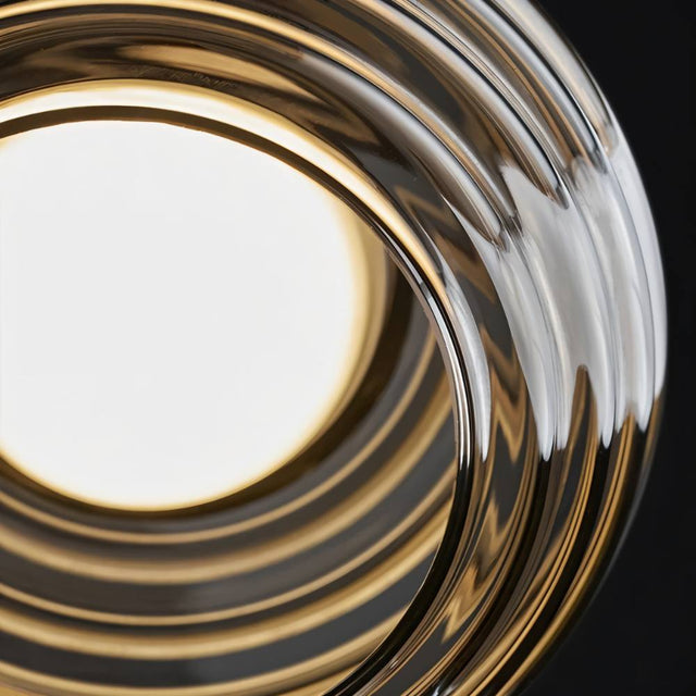 "Close-up of a smoky grey Filano pendant light showing the ribbed glass texture and illuminated bulb."