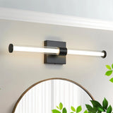 "A modern black wall lamp with a clear glass tube shade, mounted above a bathroom vanity."