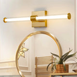 "A modern brass wall lamp with a clear glass shade, mounted above a bathroom mirror."