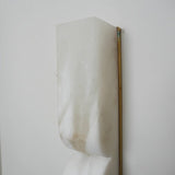 "Detail of a double curved alabaster wall lamp showing the natural stone texture."