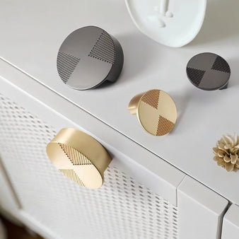 "Modern cabinet knobs with a bold circular design and etched geometric detailing."