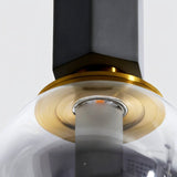 "Close-up detail of a modern pendant light showcasing the combination of concrete, metal, and smoky glass, highlighting its industrial-chic design."