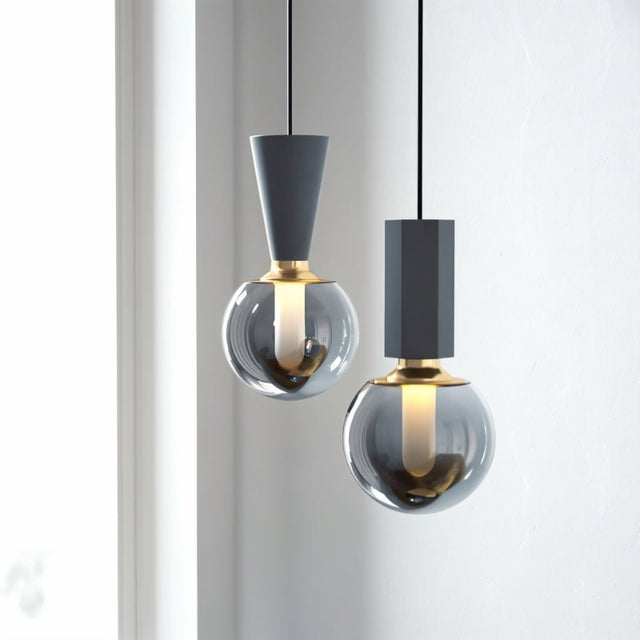 "Modern pendant lights featuring a combination of concrete, metal, and smoky glass orbs, creating a blend of industrial and sophisticated styles."