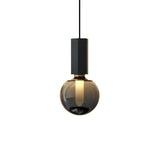 "Modern pendant light with a concrete rectangular top, metal accent, and smoky glass orb, showcasing a minimalist and sophisticated design."