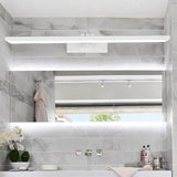 "A white LED vanity light mounted above a large bathroom mirror with a tiled wall."
