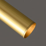"Close-up of a sleek, cylindrical brass pendant light, showcasing its minimalist design and refined finish."