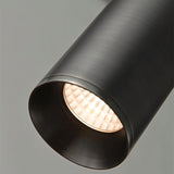 "Close-up of a sleek, cylindrical iron pendant light, showcasing its minimalist design and focused downward light."
