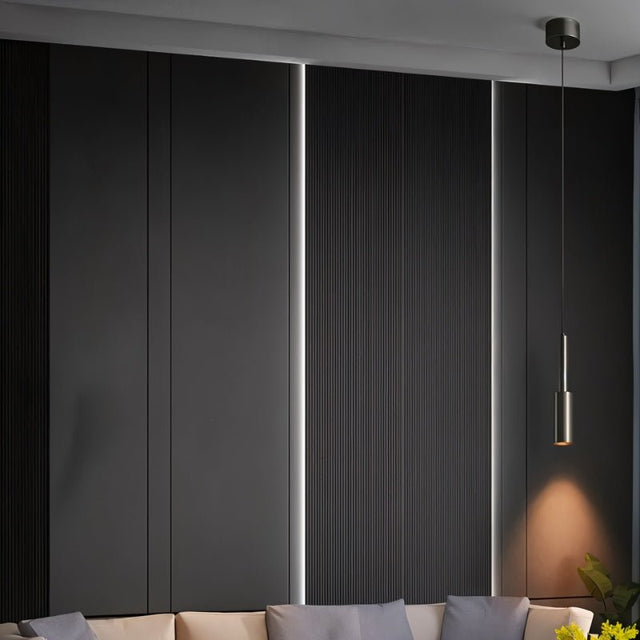 "Minimalist brass pendant light with a slender, cylindrical profile, adding a subtle, industrial touch to a modern living room with its focused downward light."