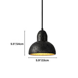 "A domed black travertine pendant light with dimensions marked, showing the stone's texture and warm light."