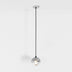 Pendant light with clear glass globe shade and black cord hanging from chrome ceiling canopy on white background.